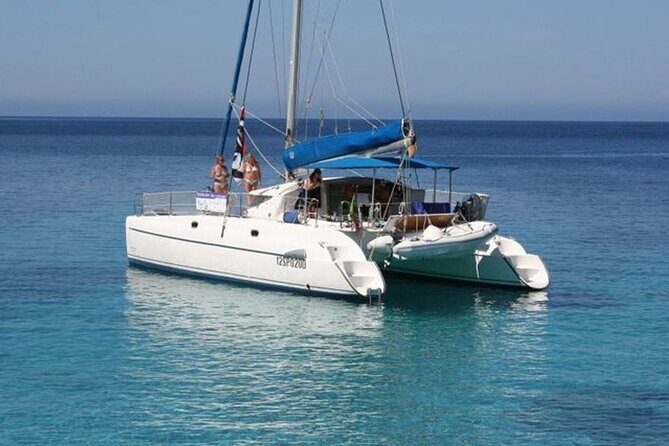 2-Catamaran tour from Cannigione to the Maddalena Archipelago - Razzoli and Santa Maria: cliffs, cala time, and national-park snorkeling zones