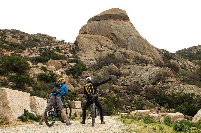 From the hills to Oasi Biderosa & Capo Comino with Electric Mountain Bikes - Stop 1: Spiaggia di Capo Comino and the lighthouse views