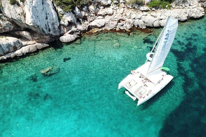 Full day Catamaran cruise in Porto Conte Natural Park - Stop 2: Cala Dragunara’s emerald water and maquis backdrop